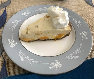 Slice of mango Key lime pie with whipped cream