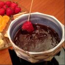 Strawberry being dipping into chocolate fondue 