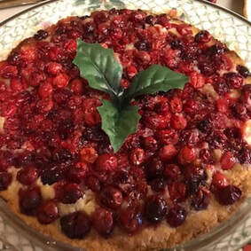 Cranberry Tart on a serving plate with a holly leaf decoration