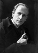 Photo of author A.A. Milne holding a pipe