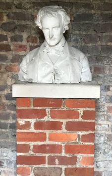 Marble bust of Poe on a brick pedestal in the courtyard of the Edgar Allan Poe Museum in Richmond, Virginia